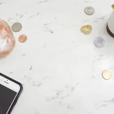 Marble styled stock photo flatlay with money, phone, succulent, and Himalayan salt candle for bloggers and female entrepreneurs. related to Exclusive Savings on Home Essentials