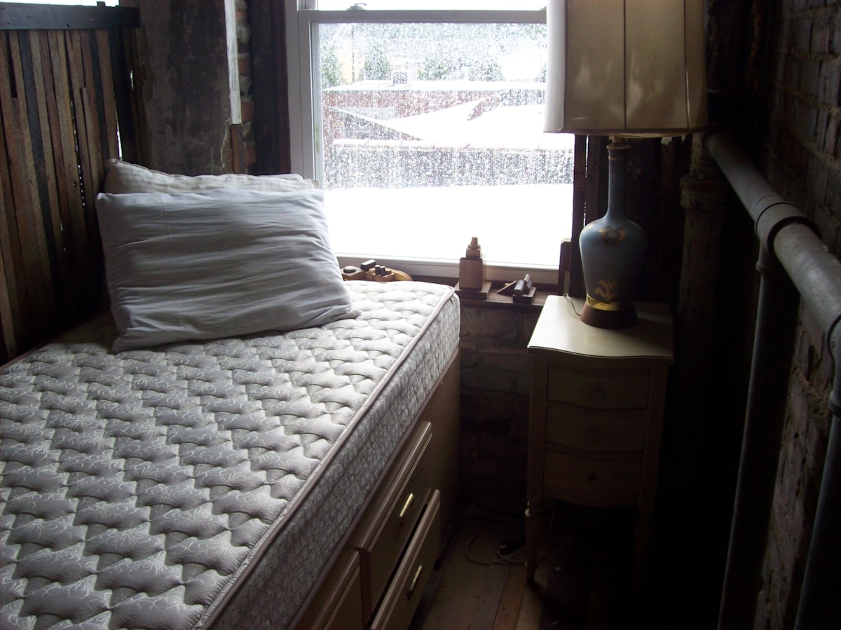 mattress and night stand in front of window related to Queen Size Coverlets - Shop Now!