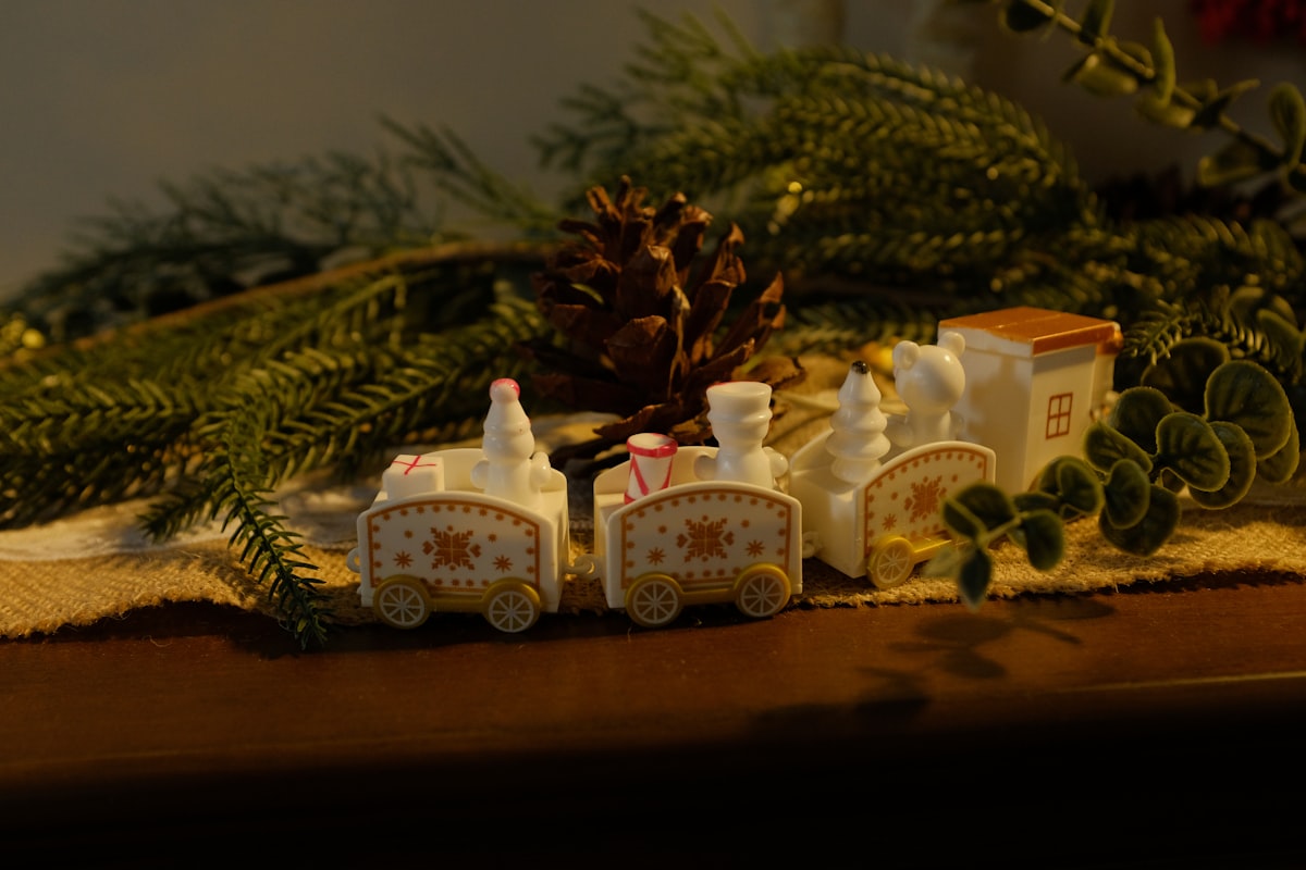 Miniature train decoration with pinecones and greenery related to All Aboard: Finding the Perfect Train Crib Bedding for Your Little One