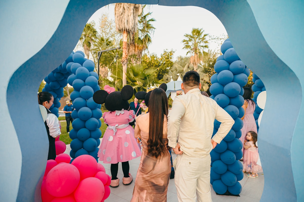 Minnie mouse greets guests at a party entrance related to The Ultimate Guide to Mickey Mouse Couch Beds