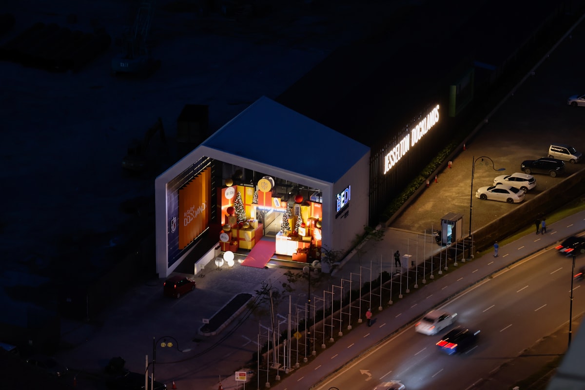 Modern building interior illuminated at night with cars nearby. related to Welcome Home: Decorating Inspiration for Your Entryway