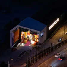 Modern building interior illuminated at night with cars nearby. related to Welcome Home: Decorating Inspiration for Your Entryway