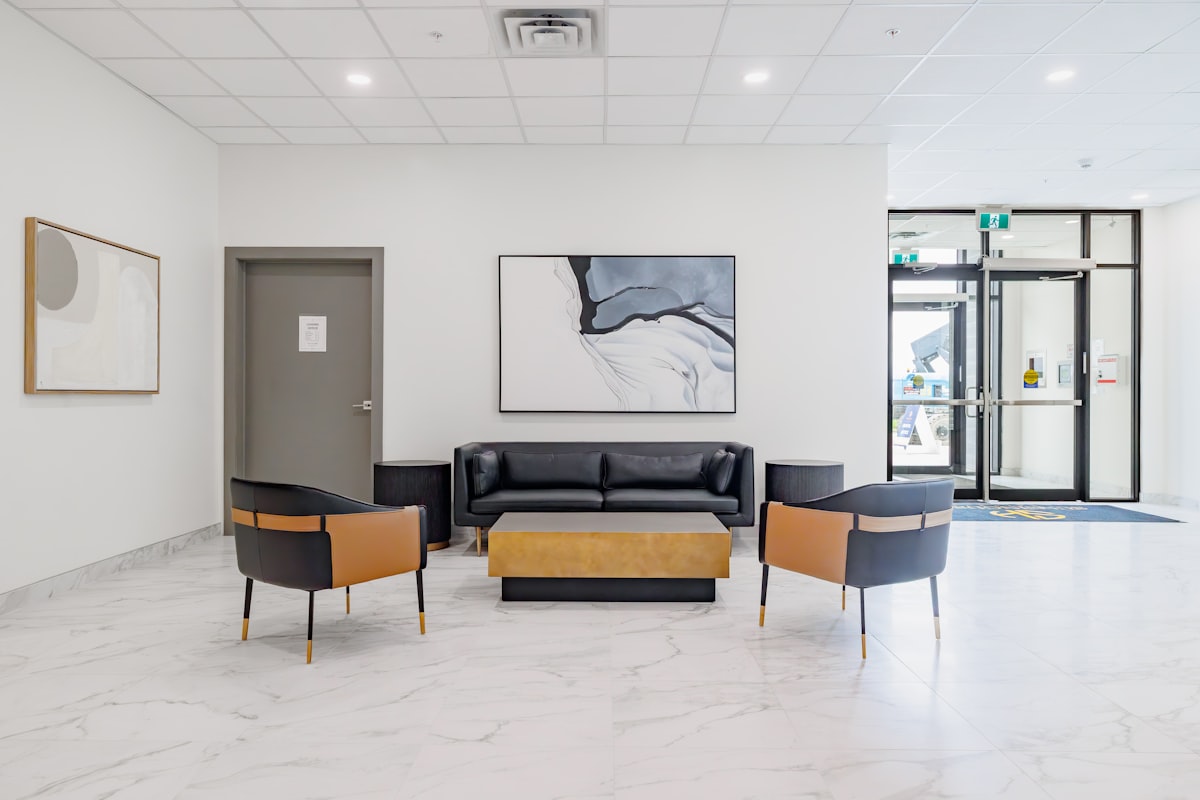 Modern lobby with black leather sofa and chairs. related to Transform Your Home with Modern Entryway Furniture