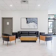 Modern lobby with black leather sofa and chairs. related to Transform Your Home with Modern Entryway Furniture