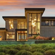 Modern luxury home with large windows at dusk related to Timeless Elegance: The Mission Style Sideboard