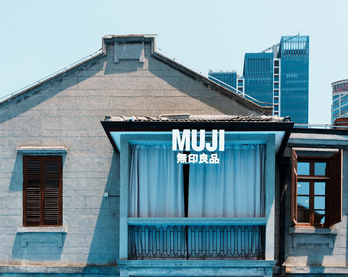 Muji store facade with modern buildings behind old building related to Minimalist Sleep Solutions for Every Bedroom