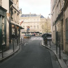 Narrow european street with buildings and distant architecture. related to Discover the Charm of the Raleigh Bed
