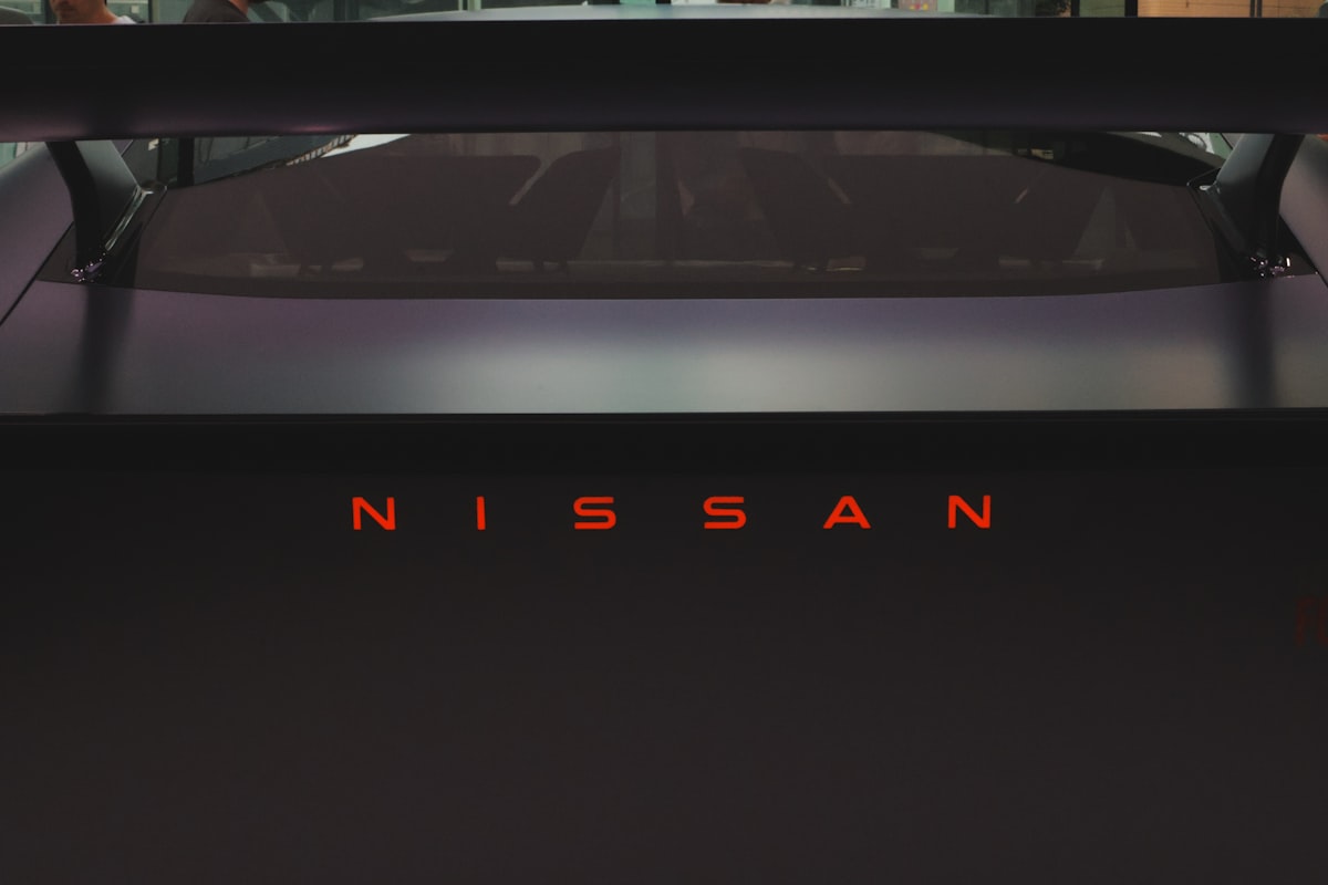 Nissan logo illuminated in red on a dark car related to Maximizing Utility: The Best Nissan Frontier Bed Racks for Adventure and Work