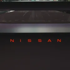 Nissan logo illuminated in red on a dark car related to Maximizing Utility: The Best Nissan Frontier Bed Racks for Adventure and Work