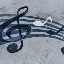 Notes drawn on a muddy road. Horizontal background with musical notes related to Transform Your Bedroom with Music Note Bedding