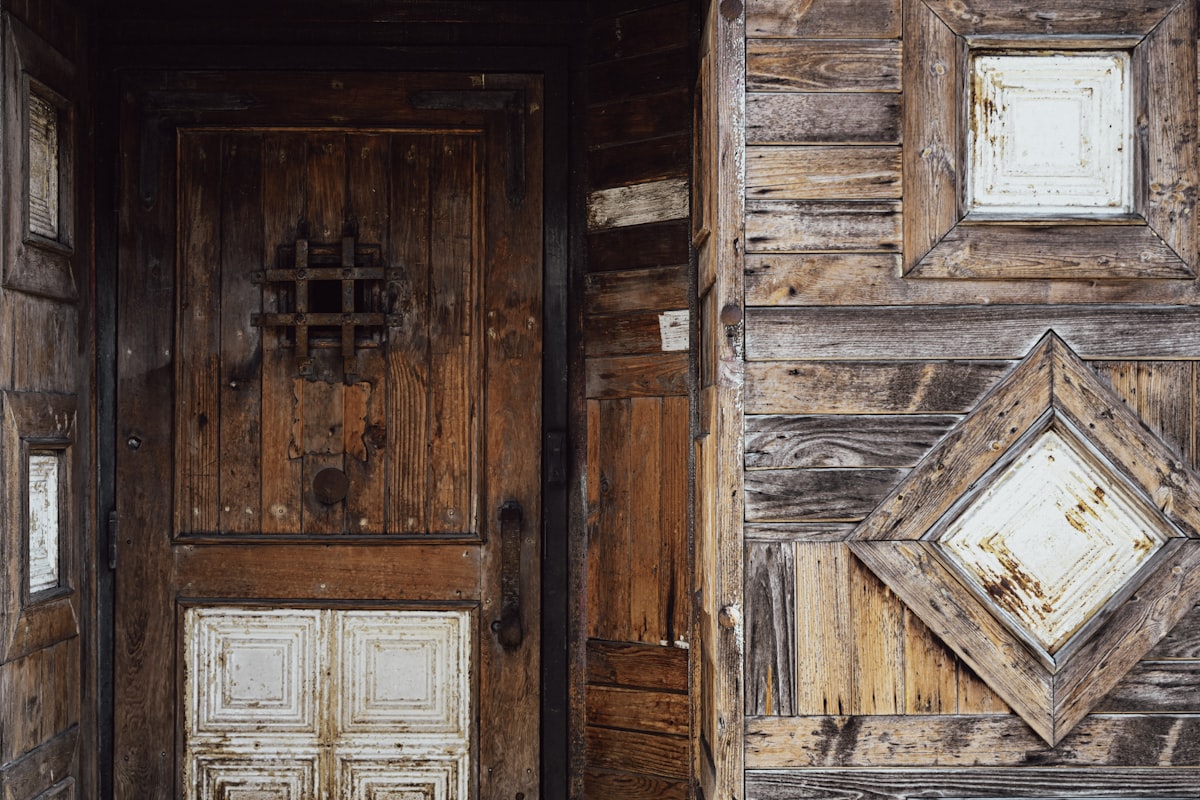 Old wooden door with weathered texture and rustic texture related to Elevate Your Home's Charm with Rustic Entryway Furniture