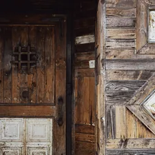 Old wooden door with weathered texture and rustic texture related to Elevate Your Home's Charm with Rustic Entryway Furniture