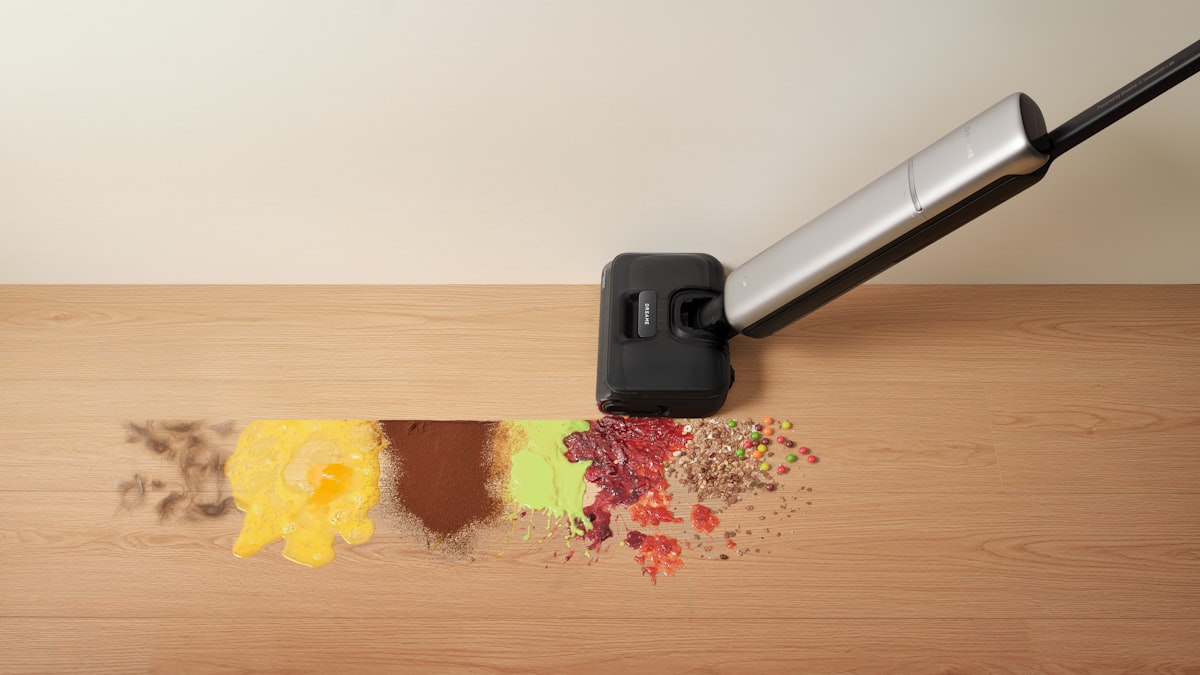 On the wooden floor, a Dreame wet dry vacuum cleans up common household spills, handling different types of everyday messes. related to Sweeping Deals: Roomba Vacuum at Bed Bath and Beyond