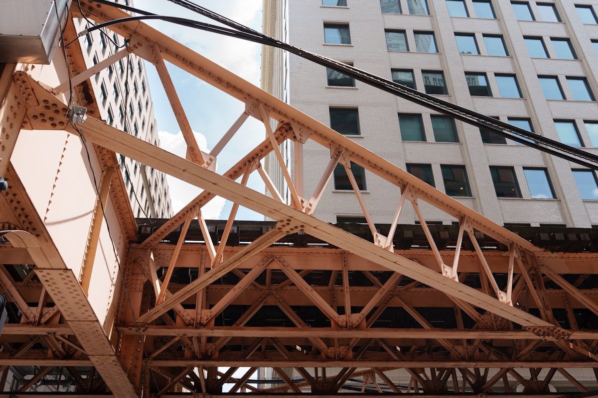 Orange metal truss structure against city buildings and sky related to Creating Your Own Elevated Garden Bed