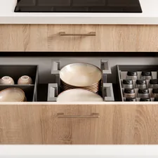 Organized kitchen drawer with plates, spices and cups in drawer organizers. related to Innovative Storage Solutions for Your Truck