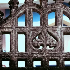 Ornate stone fence with decorative carvings related to Wrought Iron Bed Frames - Elevate Your Home's Style