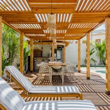 Outdoor patio with lounge chairs and dining table. related to Protect Your Outdoor Living Space with Chiminea Decking Protectors
