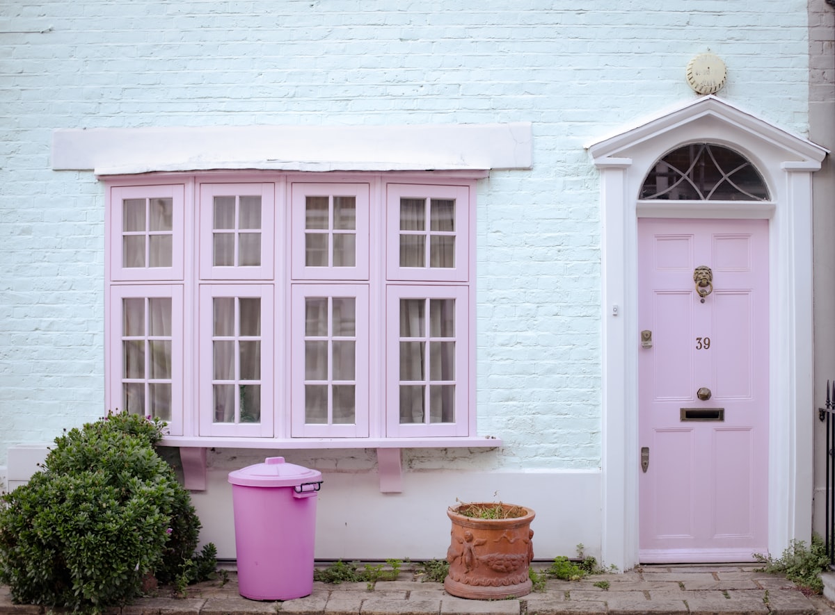 Pastel pink door and bay window on house related to Discover the Charm of Lancaster PA Bed and Breakfasts