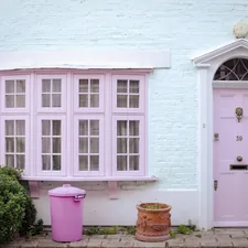 Pastel pink door and bay window on house related to Discover the Charm of Lancaster PA Bed and Breakfasts