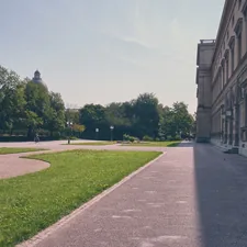 Paved path alongside a building and green park. related to Building a Raised Garden Bed