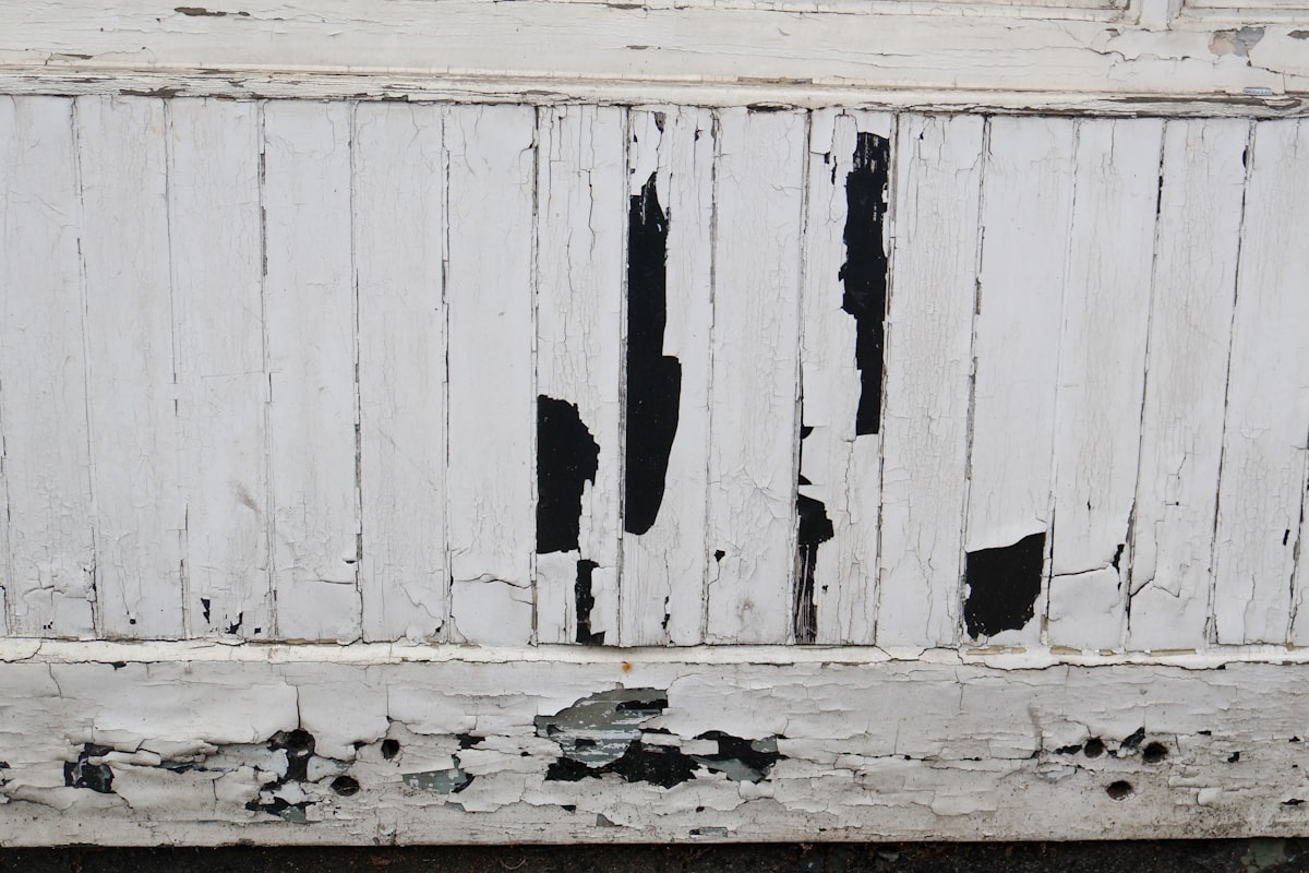 Peeling white paint on weathered wooden planks related to 10 Unique White Distressed Sideboard Ideas to Elevate Your Home Decor