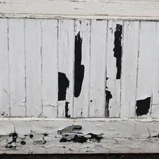 Peeling white paint on weathered wooden planks related to 10 Unique White Distressed Sideboard Ideas to Elevate Your Home Decor