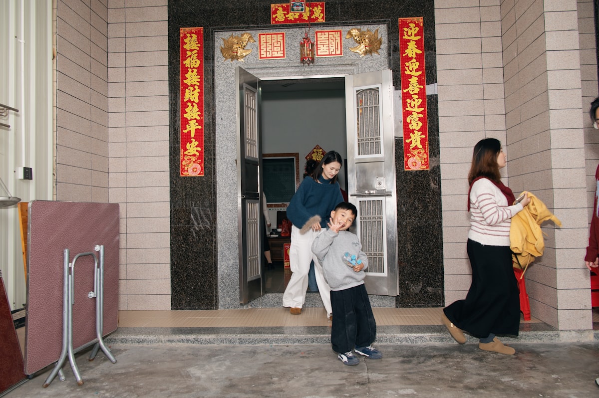 People entering a building with decorative banners. related to Stylish Red Entryway Tables to Elevate Your Home