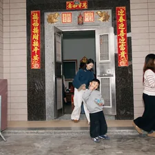 People entering a building with decorative banners. related to Stylish Red Entryway Tables to Elevate Your Home