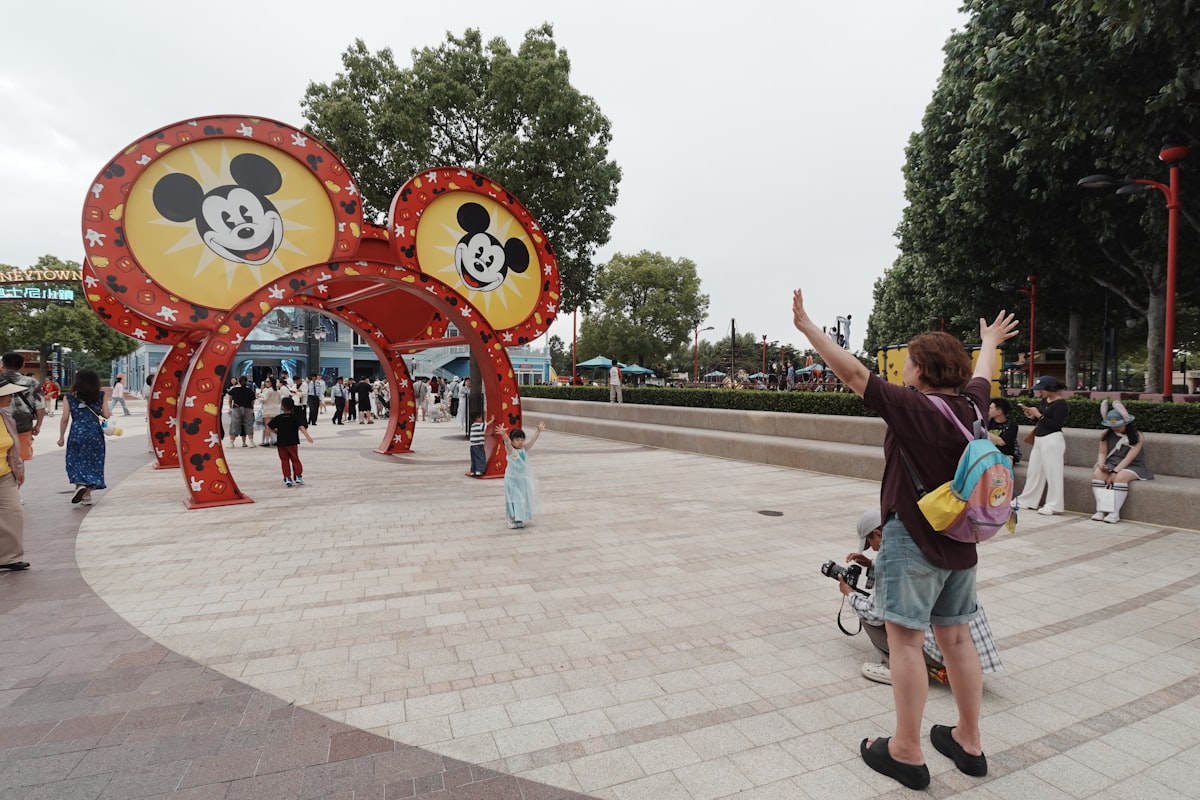 People gather near a large mickey mouse ears archway. related to The Ultimate Guide to Mickey Mouse Couch Beds