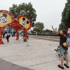 People gather near a large mickey mouse ears archway. related to The Ultimate Guide to Mickey Mouse Couch Beds