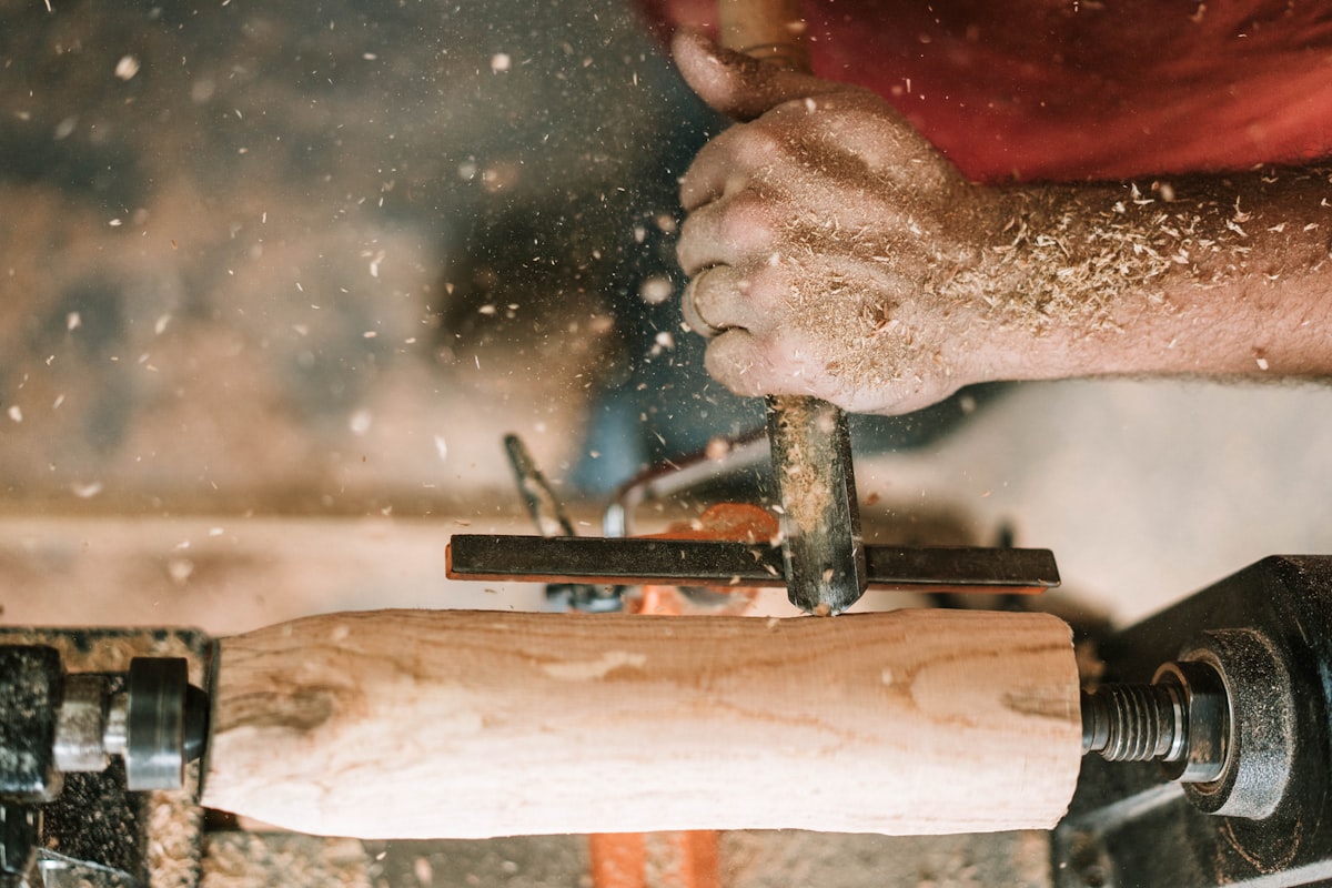 person holding gray metal tool related to Step-by-Step Guide to Crafting a Wooden Bed Frame