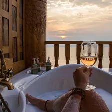 person in bathtub holding wine glass related to Sip in Style: The Ultimate Guide to Bed Bath & Beyond Wine Glasses