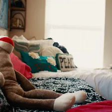 person in brown and white pants lying on bed related to Ultimate Comfort with a Giant Plush Bed