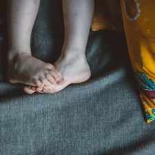 person lying on black textile related to Elevate Your Sleep Experience: The Ultimate Guide to Choosing the Perfect Footstool for Bed