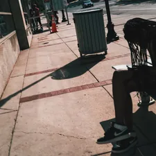 Person sitting on a bench in the sun. related to Styling Your Entryway with the Perfect Bench