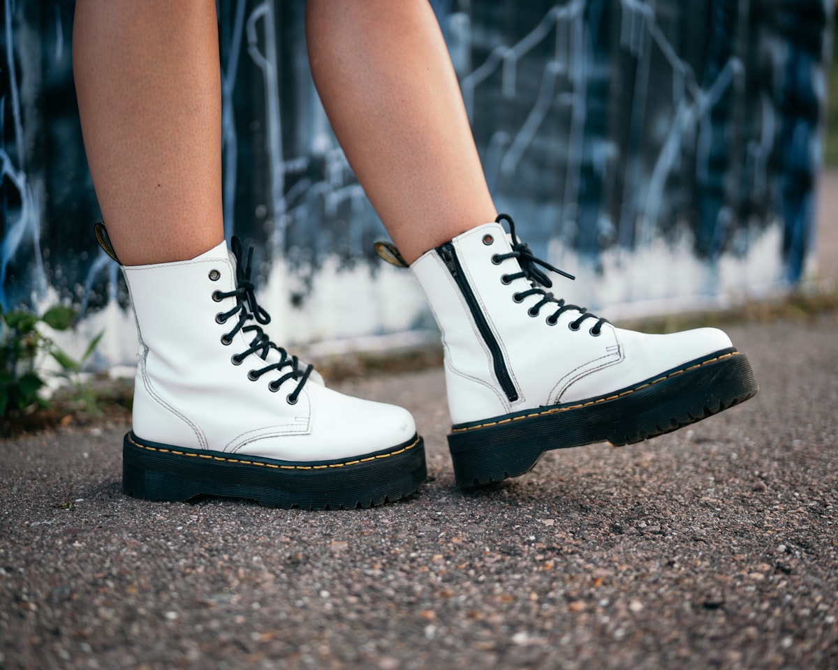 person wearing black and white high top sneakers related to The Ultimate Guide to Choosing a White Leather Platform Bed for Modern Elegance
