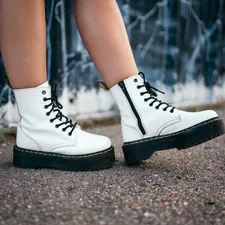 person wearing black and white high top sneakers related to The Ultimate Guide to Choosing a White Leather Platform Bed for Modern Elegance