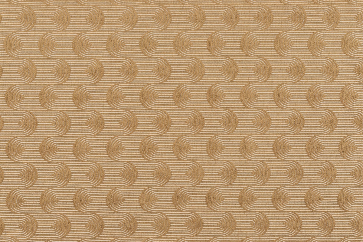 Photo of a saffron fabric swatch with repeating wavy swirls. Perfect for computer and phone wallpapers.  related to Gold Quilted Coverlet: A Luxurious Bedding Option