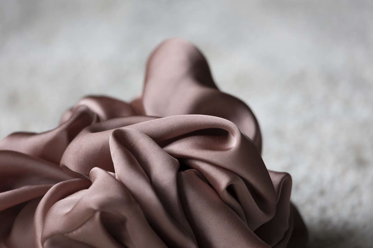 Pink fabric is artfully draped. related to The Ultimate Guide to Silk Bedding Sets