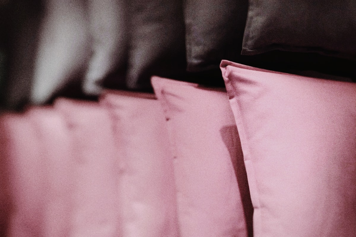 pink textile on brown textile related to Sweet Dreams in the Dark: A Guide to Black and Pink Crib Bedding