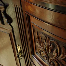 Polished carved wood ornate sideboard, dining room, Mill Rose Inn, Half Moon Bay, California, USA related to Antique Sideboards and Buffets: A Treasure Trove of Elegance and Functionality