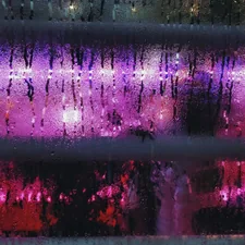 purple and white light on a city related to The Ultimate Sleep Experience: WWE Wrestling Ring Bed