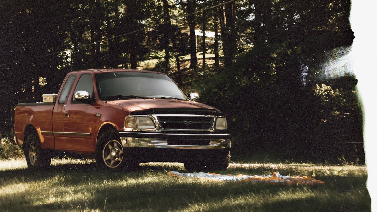 red chevrolet crew cab pickup truck parked on green grass field during daytime related to Perfect Solutions: Ford F150 Bed Cover Options