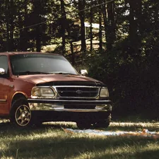 red chevrolet crew cab pickup truck parked on green grass field during daytime related to Perfect Solutions: Ford F150 Bed Cover Options