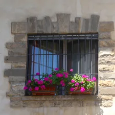 Red geraniums in window box, with bars related to How to Make a Window Box Valance