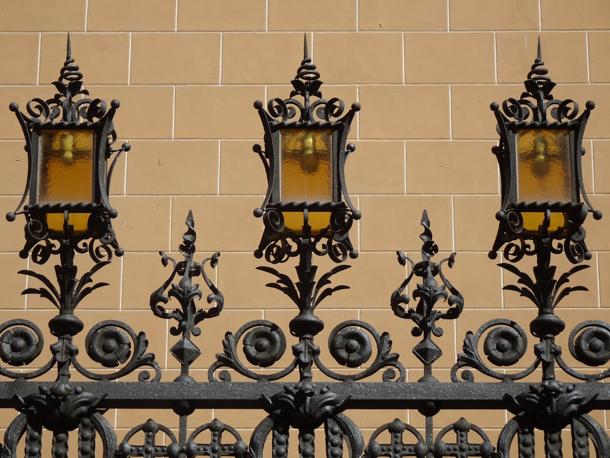 Reja de forja con faroles ámbar. related to Illuminating First Impressions: A Guide to Entryway Light Fixtures