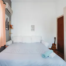 rolled blue and white towel on bed and ukulele near closed brown wooden door related to The Ultimate Guide to King Size Beds