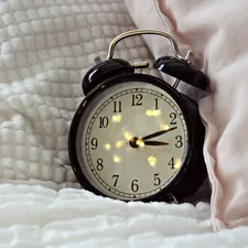 round black alarm clock displaying 3:12 related to Enchanting Bedtime Stories for Sweet Dreams