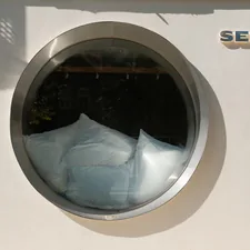 Round window reflecting white abstract shapes related to Sears Bed in a Bag: The Ultimate Bedding Solution for Every Home
