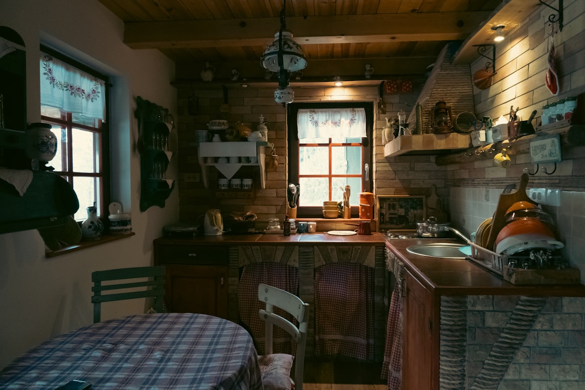 Rustic kitchen with checkered tablecloth and brick walls related to Country Kitchen Curtains & Valances